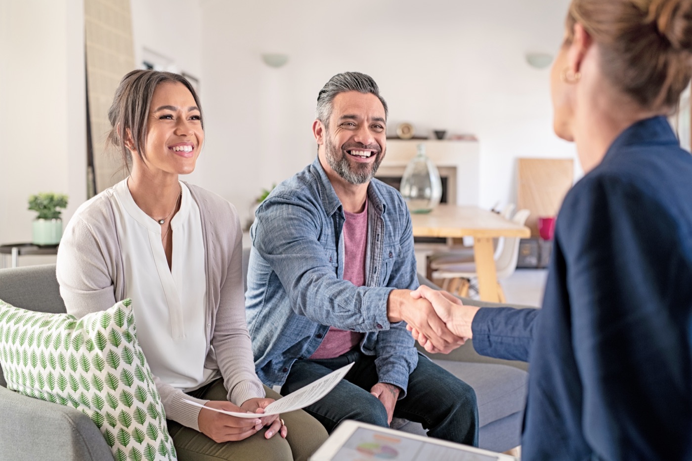 A smiling couple starting their surrogacy consultation