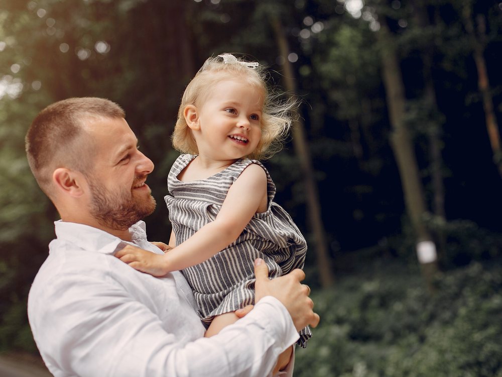 A single dad holding his daughter