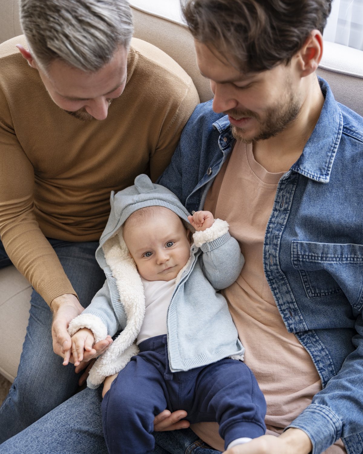 Two dads with their baby